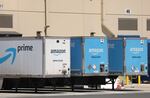 Amazon delivery trucks are parked in Richmond, Calif., on June 21.