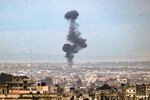 A picture taken from Rafah, in southern Gaza, shows smoke rising over buildings in Khan Younis during an Israeli bombardment on Friday, Feb. 2.