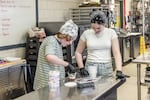 Sixth graders Connor Atkinson and Genevieve Plante work together to make yogurt parfaits in the after-school cooking club in their rural Maine school district.