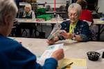 FILE - Election Worker Janet Frio inspects ballots at the Clark County Elections Office in Vancouver, Wash., on Monday, Nov. 3, 2025.
