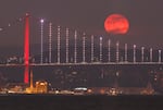 The first full moon of 2023 rises behind the 15 July Martyrs bridge in Istanbul, Turkey.