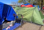 A walker is decorated with flowers, parked outside of a tent along SW 13th Avenue in Portland, April 4, 2022. Many campers stay in this area because of the close proximity Outside In where they are able to access support services.