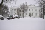 Workers remove snow from a sidewalk at the White House in Washington, DC in January 2025. A massive storm system dumped heavy snow and freezing rain on large swaths of the eastern United States, bringing an unusual amount to snow to the region.