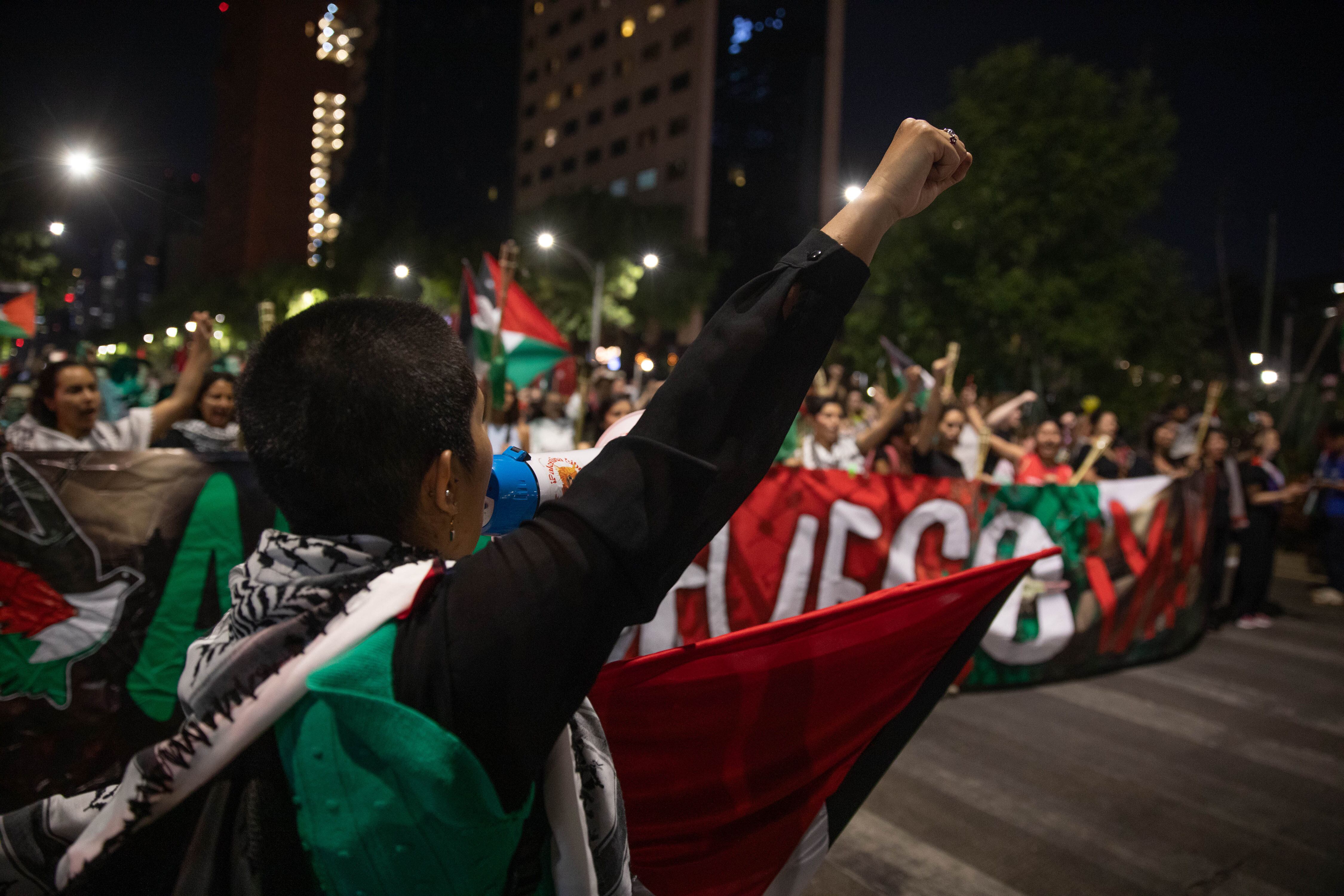 A woman raises her fist while she shouts slogans during a  demonstration against Israel's attacks on Gaza, in Mexico City,  April 13.