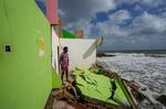 FILE - Dilrukshan Kumara looks at the ocean as he stands by the remains of his family's home in Iranawila, Sri Lanka, June 15, 2023.