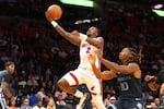FILE - Miami Heat guard Terry Rozier (2) drives to the basket as Memphis Grizzlies guard Javon Small (10) defends during the second half of an NBA preseason basketball game Friday, Oct. 17, 2025, in Miami.