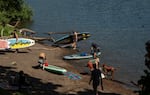 People recreate on the shores of the Wilammette River during a hot day on June 13, 2026 in West Linn, Ore.