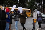 Students outside the Evergreen Public Schools administrative offices in east Vancouver wave signs condemning sexual abuse. Students said the school has recently failed to respond to reports of harassment and abuse.