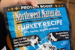 A pet store employee holds a bag of Northwest Naturals 2-pound Feline Turkey Recipe raw frozen pet food in Tigard, Ore., on Thursday, Dec. 26, 2024, after it was taken off the shelves as part of a voluntary recall by the manufacturer.