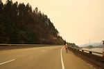 A worker walks along a closed Interstate 84 on Thursday, Sept. 14, 2017. The highway will remain closed until authorities deem it safe to re-open with the ongoing Eagle Creek Fire.