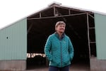 Gayle Goschie, co-owner of Goschie Farms, stands in front of a barn on her family's fourth generation farm after planting winter barley in Mount Angel, Ore., Tuesday, Oct. 31, 2023. Fall is the off-season, but recently, her farming team has been adding winter barley, a relatively newer crop in the world of beer, to their rotation. In the face of climate change, Goschie will need all the new strategies the farm can get to sustain what they produce and provide to local and larger breweries alike.