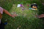 Samantha Casiano and her husband, Luis Fernando Villasana, pause at baby Halo's gravesite on June 24. Villasana had held out hope that Halo might be OK; the baby died in his arms.