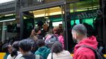 People try to board a crowded bus Monday after the subway stopped running during a power outage in Lisbon, Portugal.