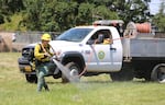 Ayva Burkhart practices a firefighting technique called "pump and roll." It would normally involve putting out a live fire, but this year's training eliminated live fire to avoid the health risks of smoke during the coronavirus pandemic.