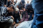 Palestinians mourn their relatives killed in the Israeli bombardment of the Gaza Strip at a hospital morgue in Deir al-Balah, Tuesday, Oct. 29, 2024.