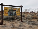 A Smokey the Bear forest fire prevention sign stands in front of snow blanketing the Sierra Nevada mountains after recent storms increased the snowpack on February 23, 2024 near Bishop, California. (Photo by Mario Tama/Getty Images)