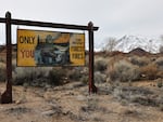 A Smokey the Bear forest fire prevention sign stands in front of snow blanketing the Sierra Nevada mountains after recent storms increased the snowpack on February 23, 2024 near Bishop, California.  (Photo by Mario Tama/Getty Images)