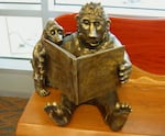 "Monsters" read on a bench at the Jackson County Public Library. By artist Pete Helzer.
