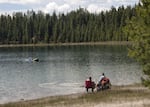 Two people fish on the edge of a lake in an undated photo provided by the Oregon Department of Fish and Wildlife.