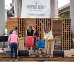 People set the stage for the Dropbox Derby auction. Dozens of handmade pieces of furniture are auctioned off to support Oregon's Tradeswomen Inc.