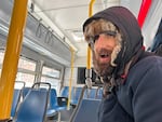 Mike rides a TriMet bus in Northwest Portland on Jan. 13, 2024, with temperatures outside hovering in the teens. Mike said he found it difficult to stay warm and that the levels of snow surprised him.