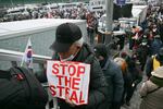 A supporter of impeached South Korean President Yoon Suk Yeol holds a placard reading "Stop the Steal" as he takes part in a rally near Yoon's residence in Seoul on Sunday.