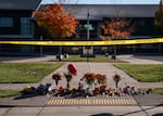 Candles, flowers and other items sit in a makeshift memorial in front of Silver Rail Elementary School in Bend, Ore., on Oct. 16, 2026. 