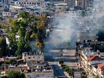 A cloud of smoke billows during an Israeli army raid in Jenin in the occupied West Bank on June 6. The Israeli military said it was investigating an incident in which a wounded Palestinian man was strapped to an Israeli military jeep while forces carried out "counterterrorism operations" in Jenin on Saturday. 