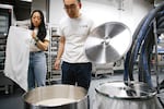 Sophia and Peter Jung, co-founders of Rainbrew, check on the production of their Korean rice wine on Thursday, May 22, 2025, at the brewery in Woodinville, Wash.
