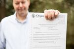 Mats Järlström displays the document he received from the Oregon State Board of Examiners for Engineering and Land Surveying. 