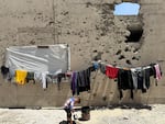 A boy plays near the encampment in Gaza City on May 25, 2025.