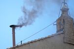 Black smoke billows from the chimney of the Sistine Chapel during the conclave to elect a new pope, at the Vatican, Thursday, May 8, 2025.