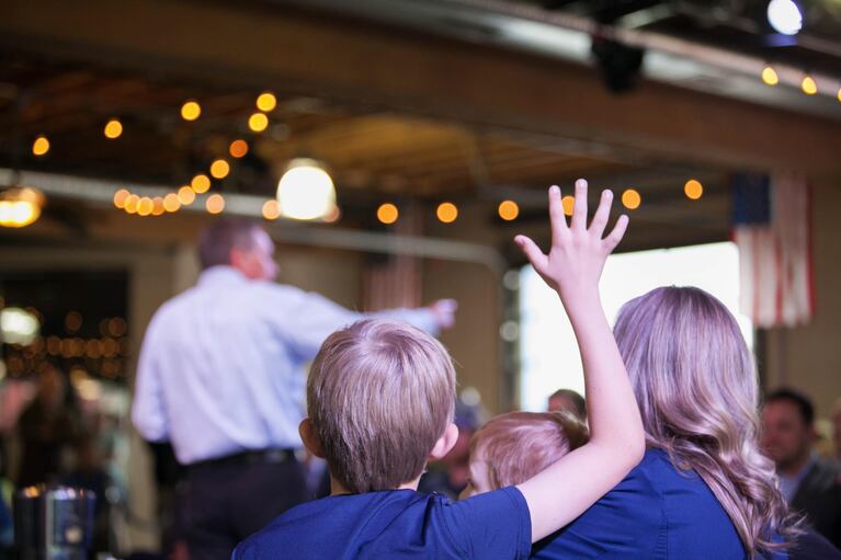 A child raises his hand to ask a question of the governor. Theodore, 10, asked Kasich how he would combat the Islamic State.