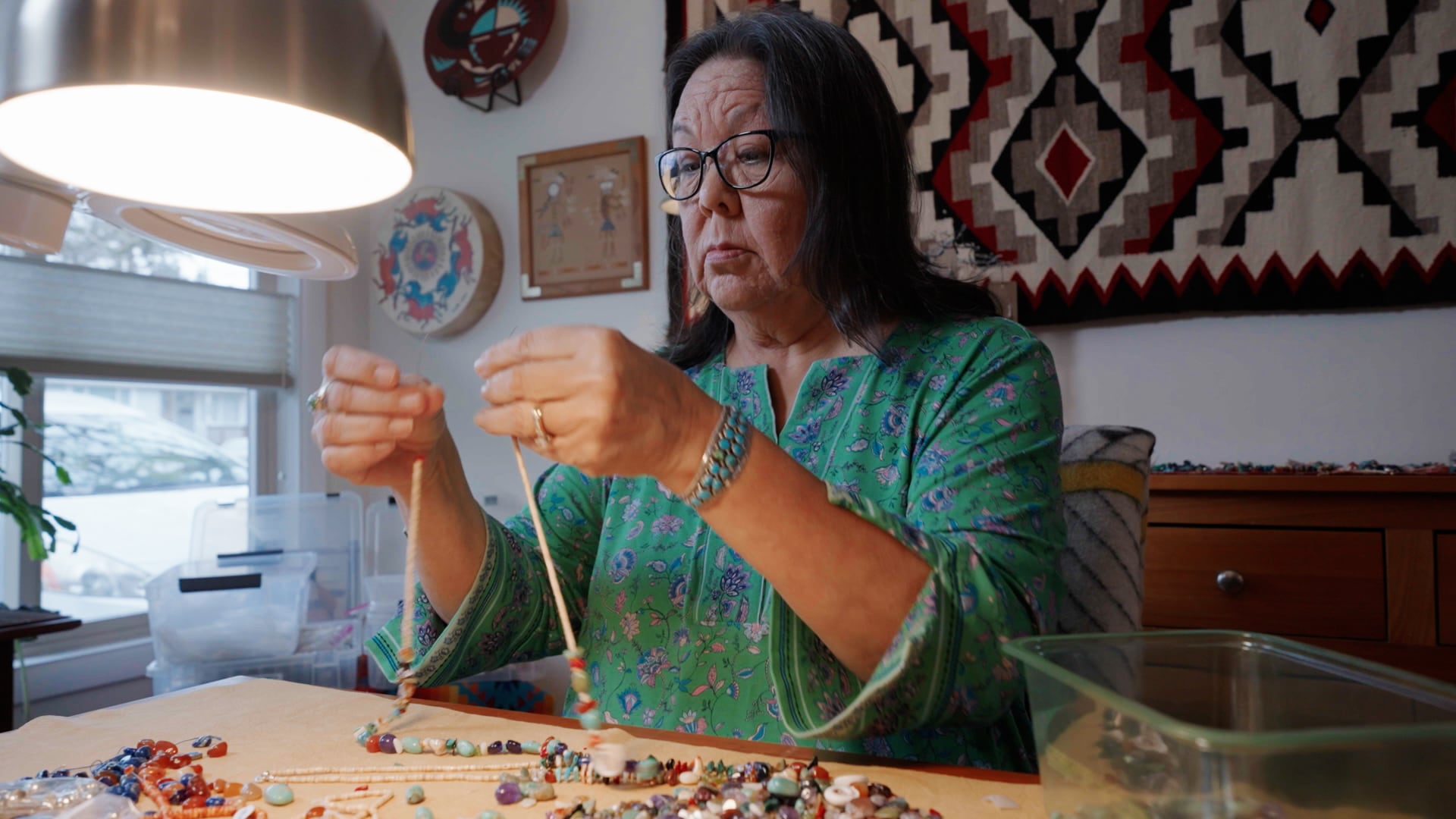 Marcy Middleton creates a beaded necklace at her home in Eugene on Dec. 10, 2024. Middleton helped bring the Native American Arts & Crafts Market to the Oregon Country Fair for the first time in 2024.