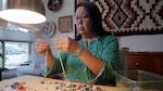 Marcy Middleton creates a beaded necklace at her home in Eugene on Dec. 10, 2024. Middleton helped bring the Native American Arts & Crafts Market to the Oregon Country Fair for the first time in 2024. 
