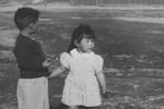 Children Kiyoshi and Satsuki Ina stand in the Tule Lake Relocation Center during World War II. The two survived the internment camp and will tell their stories at the Tule Lake National Monument on Saturday, Aug. 23, 2025.