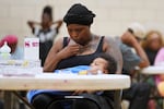 A woman sits inside the City Life Center as she waits for food in Gary, Ind., Thursday, Aug. 20, 2026, more than a week after a deadly storm passed through the area.