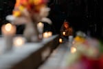 An attendee holds a candle during a vigil at Drake Park after three children and a teacher were killed in a shooting at Silver Rail Elementary School in Bend, Ore. on Oct. 15, 2026. 