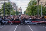 People hold banners with writing reading "Serbia against violence" during a march against violence in Belgrade, Serbia, on Friday, May 12, 2023.