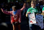 A counter protestor, left, raises her arms next to people rallying to support Indiana Fever guard Sophie Cunningham after her comments on transgender athletes in women's sports before a WNBA basketball game between the Portland Fire and the Indiana Fever in Portland, Ore., Friday, July 31, 2026.