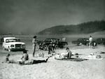 Cars and bathers on an Oregon beach.