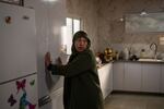 Mayada Abu Queider stands in her kitchen. She says her children were hiding under a table during the Oct. 7 attack because the village did not have a rocket shelter.