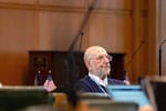 Rep. Mitch Greenlick, D-Portland, sits at a desk on the House floor at the Capitol in Salem, Oregon.