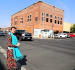 Stephanie Huffman stands outside the Odd Fellows Building in downtown Pendleton, Ore. The building is being renovated for residential lofts and a restaurant.