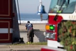 A firefighter patrols Ocean Beach in San Francisco during a tsunami warning on Thursday, Dec. 5, 2024. (AP Photo/Emily Steinberger)