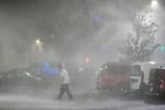 Max Watts, of Buford, Ga., walks in the parking lot to check on a trailer parked outside the hotel where he is riding out Hurricane Milton with coworkers in Tampa, Fla. Watts, who works for a towing company, was deployed with colleagues to Florida to aid in the aftermath of the storm.