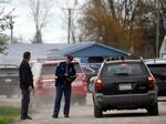 A law enforcement official monitors the perimeter of the Swan Creek Boat Club after a driver crashed a vehicle through a building where a children's birthday party was taking place, Saturday, April 20, 2024, in Berlin Township, Mich.