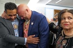 John Lowery, chairman of the Lumbee Tribe of North Carolina and a state representative (center) is comforted, as he cries tears of joy. Lowery and other members of the tribe gathered in Washington, D.C., to mark the passage of a bill granting full federal recognition on Wednesday.