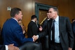 Jay Clayton, left, shakes hands with Sen. Mark Warner, D-Va., following his confirmation hearing for Director of National Intelligence on July 15, 2026. Warner says administration officials have failed to provide legally-mandated pre-election reports to Congress on foreign election meddling efforts.