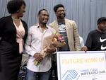 In this video screenshot, PPS deputy superintendent of instruction Cheryl Proctor, left, and Portland's Boys & Girls Club CEO Terry Johnson, center, celebrate with first-grade teacher Lionel Clegg, second from left, at a surprise event on Oct. 4, 2023, at Woodlawn Elementary School in Northeast Portland. A Boys & Girls Club in Southeast Portland will be renamed in his honor.